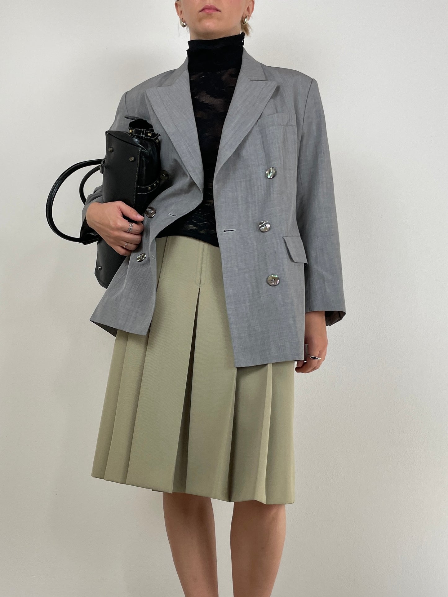 Gonna sartoriale a pieghe in lana color pistacchio