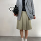 Gonna sartoriale a pieghe in lana color pistacchio