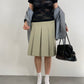 Gonna sartoriale a pieghe in lana color pistacchio