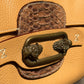 Borsa in vera pelle con dettagli in metallo